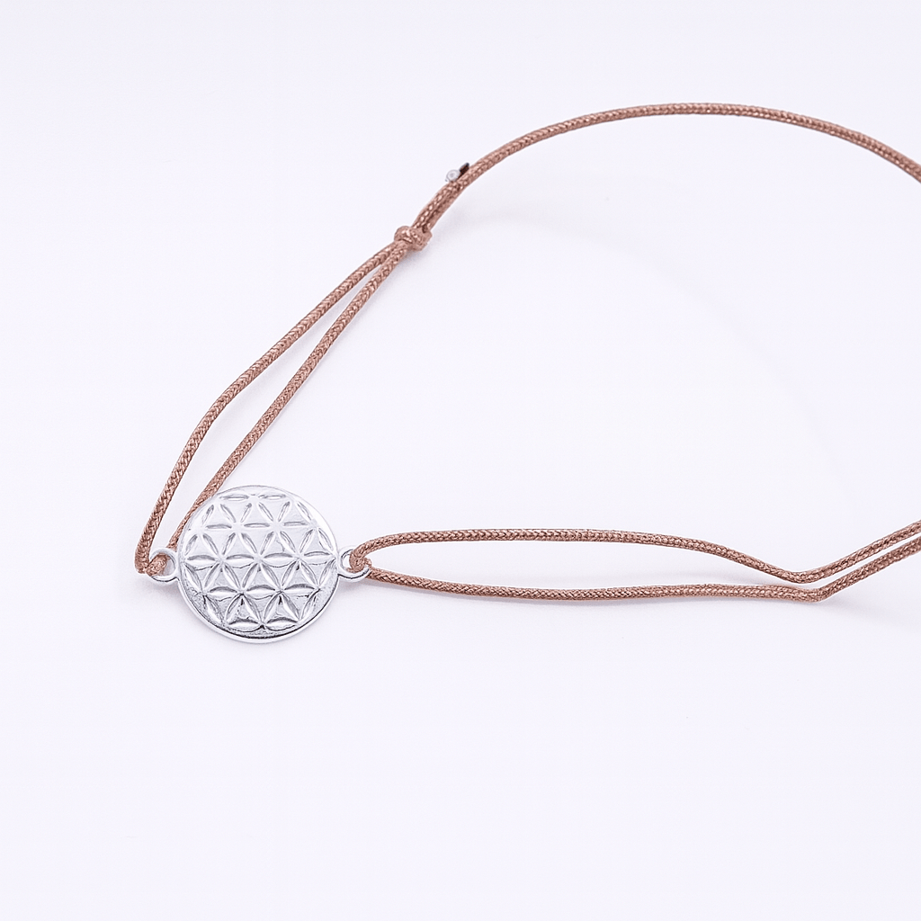 Verstellbares Armband mit braunem Band und silberner Blume des Lebens als Anhänger – Symbolschmuck für Harmonie und Balance.